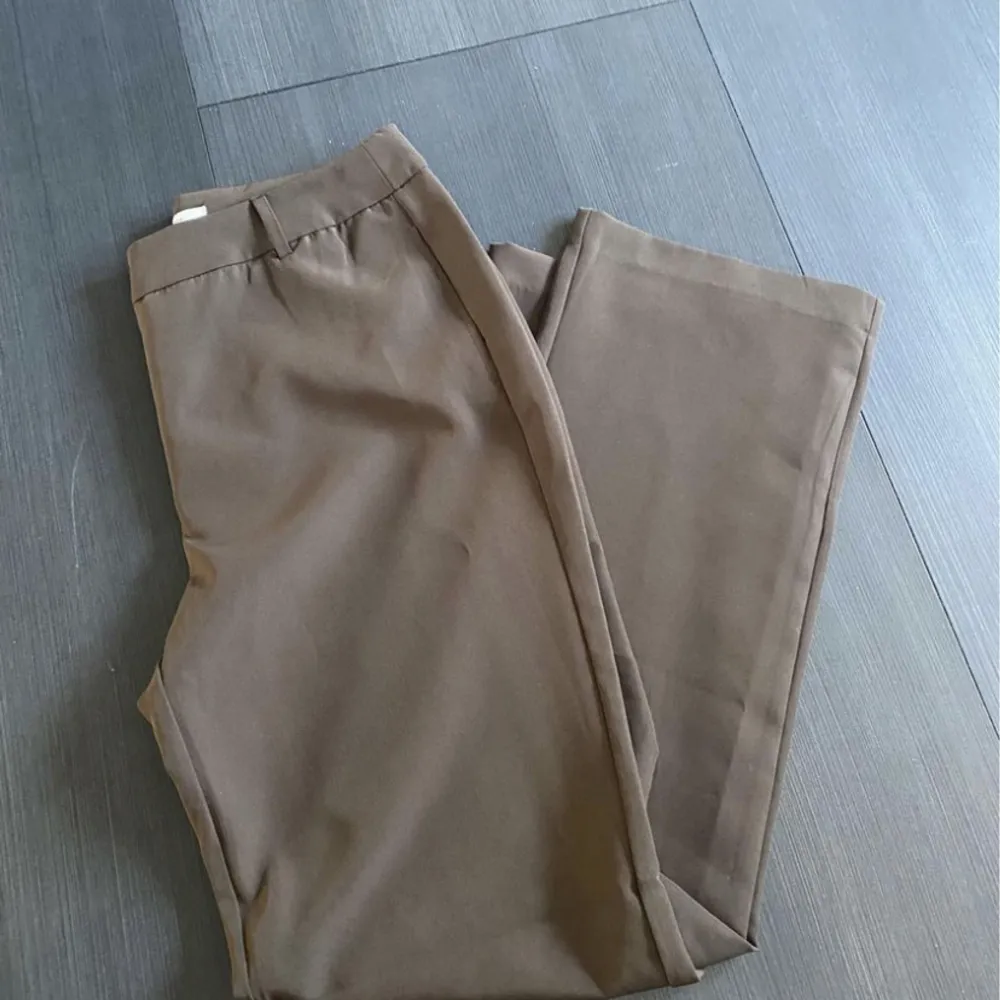 Säljer ett par oanvända bruna kostymbyxor från Only i storlek 40. Köpta för 339kr. Är mer bruna i verkligheten än på bild!. Jeans & Byxor.