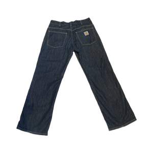 Relaxed fit Carhartt dark blue jeans with minor flaws, but overall MINT condition. Size 32X32
