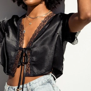 Topp/blus med knytning - Världens sötaste topp från Princess Polly. Säljer den både i svart och vit. Använda 1 gång. Köpta för 500 kr/styck. Köparen står för frakt 🤍