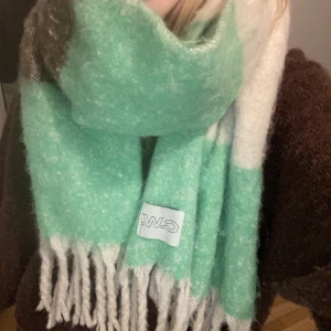 Carin Wester halsduk - Halsduk från Carin Wester! Färgerna är beige, grön, brun och lila. Köpt i december och endast använd fåtal gånger, frakt står köparen för 