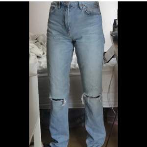 Blåa Straight jeans med hål på knäna, storlek 38. Aldrig använda och prislappen sitter kvar.