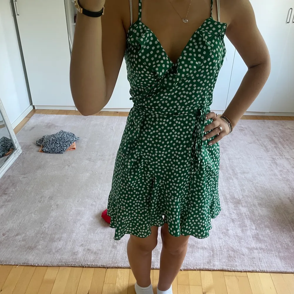 Jättesöt grön klänning med blommor som du knyter själv efter egen storlek, perfekt för sommaren. Klänningar.