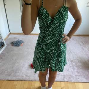 Jättesöt grön klänning med blommor som du knyter själv efter egen storlek, perfekt för sommaren