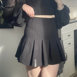 Tenniskjol  - Svart tennis skirt från Bershka. Väl använd därmed lite lösa trådar på ena sidan. 