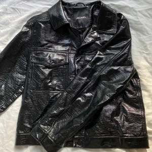 Lackad jacka  - Den perfekta höstjackan! Skitsnygg lackad jacka som passar till allt! Det är en XS men har väldigt boxig form så den sitter som en oversized S. Kan lätt ha en tjockare tröja/hoodie under. 