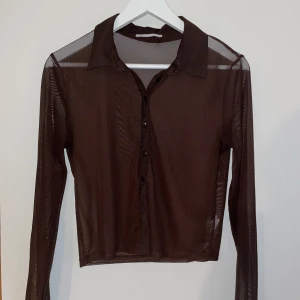 Meshtopp - Perfekt festtopp i mesh med skjort-stil. Strl. L men passar som M.