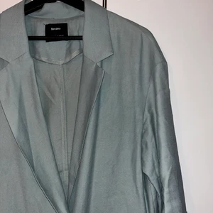 Kavaj - Turkos/grå kavaj med kortare ärmar. Använd men i fin skick. Strl M. 