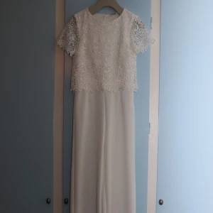 Vit playsuit i spets  - Vit playsuit i spets från BodyFlirt i storlek 38. Använd vid ett tillfälle och därför i mycket fint skick! Skymd dragkedja bak. Vida/raka ben. Kan skickas fler bilder om så önskas. Möttas upp, alternativt skickas i överenskommelse om fraktkostnad!