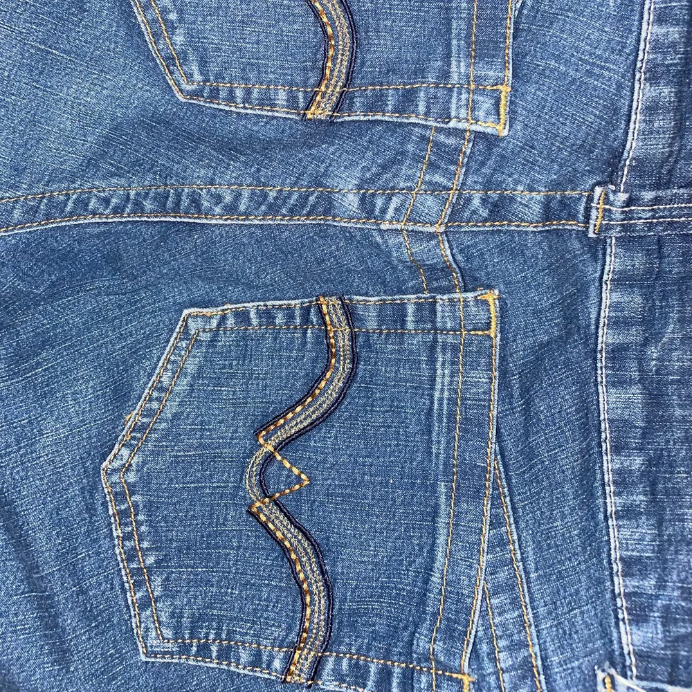 Snygga mörkblåa straight jeans med coolt mönster på bakfickorna. Jeans & Byxor.