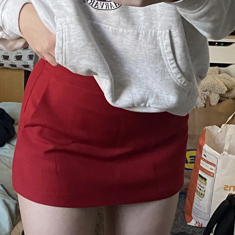 En röd kort kjol men shorts insydda. Skön men väldigt kort. Jag är 163 cm lång. Fotvård framfickor. Dragkedja på sidan. . Kjolar.