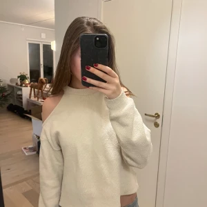 Beige offshoulder tröja - Säljer en mysig beige offshoulder tröja med långa ärmar. Perfekt för en avslappnad stil. Tröjan har en lös passform och är tillverkad i ett mjukt material.