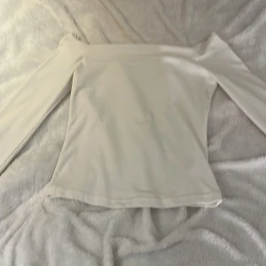 Vit offshoulder topp - Säljer en vit offshoulder topp med långa ärmar. Nästan helt oanvänd. Storlek okänd. Märke okänd. 