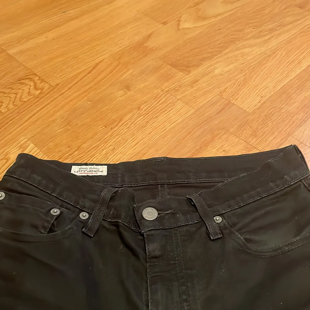 Säljer ett par svarta jeans från Levi's i storlek W29 L32. De har en klassisk design med fem fickor och knappgylf. Jeansen är i bra skick och passar perfekt för både vardag och fest. De är tillverkade i ett slitstarkt material som håller länge. Modell: 511. Jeans & Byxor.