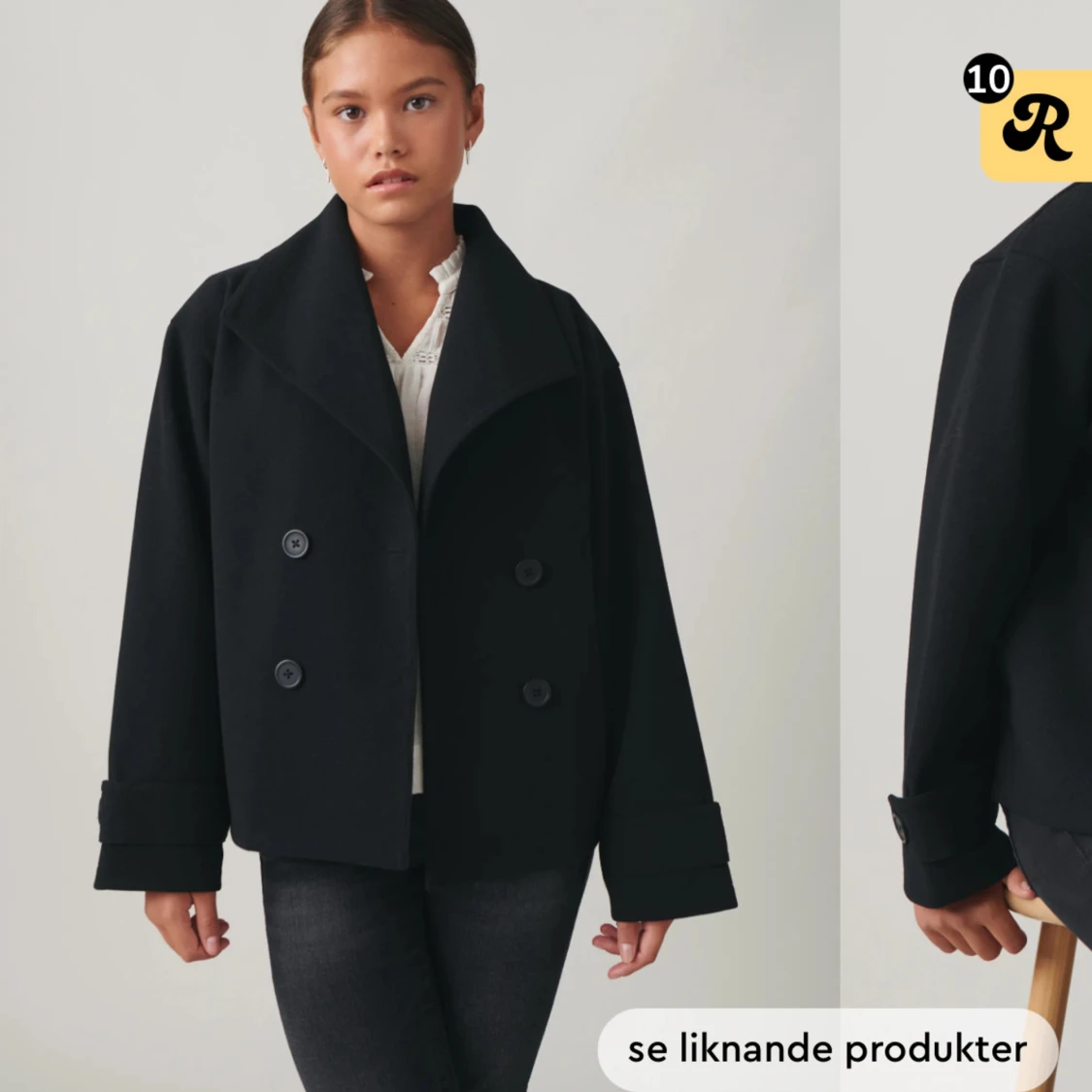 Svart kappa med knappar