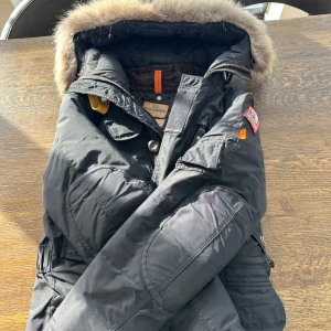 Svart vinterjacka  - Säljer en svart vinterjacka  med pälsfodrad huva och flera praktiska fickor. Jackan har dragkedja och knappar framtill samt quiltad insida för extra värme. Perfekt för kalla dagar! 🖤