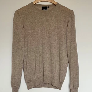 Oscar Jacobson tröja - Oscar Jacobson beige tröja – stilren, tidlös & bekväm (Storlek S)  Säljer en elegant och högkvalitativ tröja från Oscar Jacobson i en snygg beige nyans. Perfekt för dig som vill ha en mångsidig tröja som funkar både till vardags och mer uppklädda tillfällen. Hör av dig vid intresse 📌  ✔ material – 100% ull   📏 Längd: 65 cm 📏 Bredd (mätt över bröstet): 46 cm 