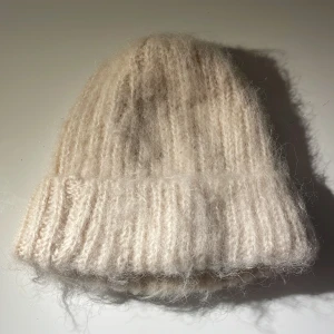 Beige stickad mössa - Mysig beige stickad mössa som passar bra till både höst och vinteroutfits.