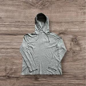 Grå hoodie från Ralph Lauren - Säljer en stilren grå hoodie från Ralph Lauren med broderad logga på bröstet. Tröjan har långa ärmar och en praktisk huva med dragsko. Perfekt för en avslappnad look.