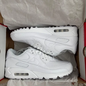 Vita Nike Air Max 90 - Säljer ett par klassiska vita Nike Air Max 90 sneakers. Helt nya alldrig använda nypris 1845,00kr. 
