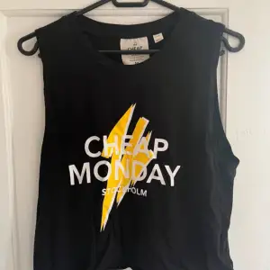 Cool svart ärmlös topp från Cheap Monday ☺️ Perfekt för en avslappnad stil eller sommarens festivaler. Tillverkad i mjukt material för en bekväm passform. Kortare variant ☺️