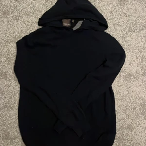 Mörkblå cashmere hoodie från Oscar Jacobson - Säljer en stilren mörkblå hoodie från Oscar Jacobson i storlek S. Modell är Pascal och den är i cashmere. Passar perfekt nu till höst och vinter!
