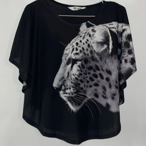 Snygg leopard topp/t-shirt - Säljer en svart topp/t-shirt från H&M med ett stort leopardtryck på framsidan. Materialet är jätte mjukt🌸 Köpt 2018 och finns inte i produktion längre. Tycker den är suuper snygg men måste rensa garderoben… storleken är 158-164cm men skulle säga S