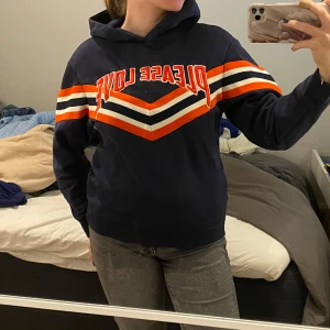 Mörkblå hoodie med texten 'Please Love' - Säljer en snygg mörkblå hoodie. Den har långa ärmar och en klassisk hoodie-stil med en bekväm passform. Den är från Sandros Paris och nypris är 999kr