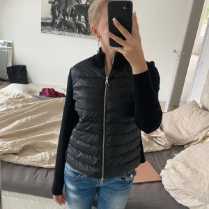 Svart moncler cardigan - Svart Moncler cardigan, köpt 2023 på NK i Göteborg. Knappt använd, storlek XS. Dun på fram o baksida