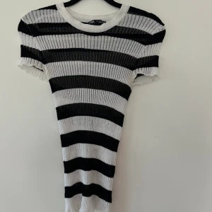 Tajt topp zara - Tajt topp/T-shirt från zara i nyskick! Sitter tajt runt kroppen! Snygg till alla underdelar:)