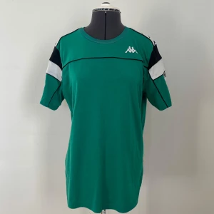 T-shirt från Kappa - Snygg grön t-shirt från Kappa med svarta och vita detaljer av deras klassisk logga. 
