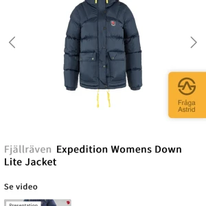 Expedition Womens Down Lite Jacket från Fjällräven - Säljer en mörkblå dunjacka från Fjällräven, perfekt för kalla vinterdagar. Jackan har en pufferdesign med långa ärmar och praktiska fickor framtill. Den är utrustad med en huva och justerbara snören i nederkant för extra värme och komfort.