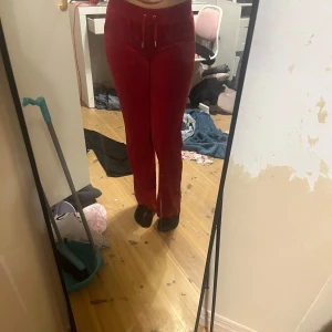 Röda juicy byxor - Jag säljer nu mina röda juicy byxor då jag inte längre andvänder dom. De är andvänd 2-5 gånger men har ett litet håll som knappt märks (de sista bilden). Byxorna är lite mer lågmidjade än vad de jag tidigare haft på mig.