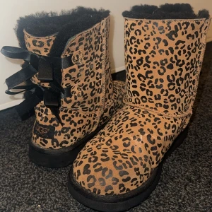 Uggs - Säljer mina söta leopard uggs med rosetter baktill. Använda men inga defekter med undantaget på en liten ”repa” (se sista bilden), går dock säkert o fixa. Står storlek 35 men passar mig som har 37-38. Frakt tillkommer. Hör gärna av dig vid fler frågor eller bilder. 
