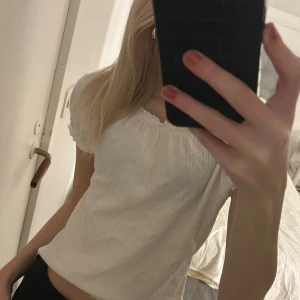 Vit blus med volangdetaljer - Säljer en söt vit blus med volangdetaljer i storlek S. Har aldrig använts!🤍🤍