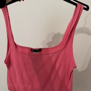 Rosa ribbad linnetopp från Zara - Säljer en snygg rosa ribbad linnetopp från Zara. Perfekt för varma dagar med sin ärmlösa design och mjuka material. Passar utmärkt till både jeans och kjol. 🌸 ANVÄND EN GÅNG!! Väldigt liten i storleken oxå, passar s/m