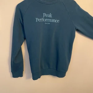 Blå tröja från Peak Performance - Säljer en snygg blå tröja från Peak Performance i storlek 160. Den är långärmad. Perfekt för både vardag och träning. Tröjan är i väldigt bra skick 9/10. Använd max 5 gånger. Nypris 750‼️