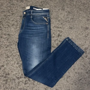Blå jeans från Replay - Snygga blå jeans från Replay med klassisk femficksdesign och dragkedja. De har en normal passform och är perfekta för en avslappnad stil. Helt nya med lapparna kvar. Storlek 32/32.       Pris går att diskutera vid snabb affär. 