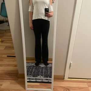 Vit topp med öppna axlar - Säljer en vit topp med öppna axlar och korta ärmar. Toppen har en rund halsringning och är tillverkad i ett mjukt material som ger en bekväm passform. Perfekt för en avslappnad stil.