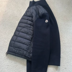 Svart jacka från Moncler - Snygg mörkblå cardigan från Moncler med quiltad framsida och dragkedja. Jackan är i nyskick. Pris kan diskuteras vid direkt köp.