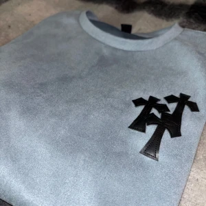 Ljusblå t-shirt med svart tryck - Snygg ljusblå t-shirt med ett unikt svart tryck på bröstet. Perfekt för en avslappnad stil. T-shirten har en klassisk passform och är kortärmad.