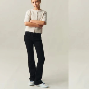 Svarta jeansbyxor - Snygga svarta jeansbyxor med hög midja och en tight passform. Perfekta för en stilren look. Byxorna har klassiska femficksdetaljer och en knappgylf.