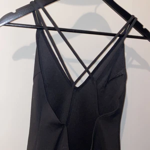 Svart klänning - Svart klänning med låg rygg med korsadeband, från bikbok, storlek s