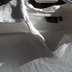 Tshirt med broderad krage - Tshirt med superfina detajer av proderi! Fint skick, knappt använd så det finns inget fel alls! Ganska boxig passform men samtidigt liten i storleken, på mig som brukar ha M är denna normal lite loose fit. Samma boderi detaljer på ärmen som på kragen.. Verkligen unik😊