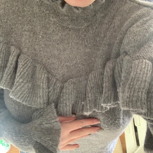 Stickad tröja grå med volanger - Så fin stickad tröja med volanger från Gina i storlek XS nyskick! Köptes för 499kr🥰