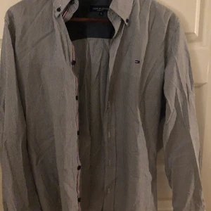 Tommy Hilfiger skjorta  - En blå/vit randig skjorta i storlek S från Tommy Hilfiger. Knappt använd och i bra skick! Kan användas till speciella tillfällen eller som en sommarskjorta. Säljs för 50kr.