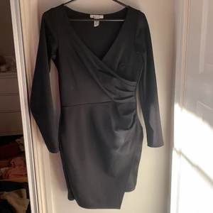 Svart klänning - Svart klänning från nlyone i storlek S. Åtsittande, med omlott både vid bröstet och på kjolen. 