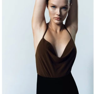 Zara topp - Säljer denna jättefina bruna toppen från Zara i storlek S då den tyvärr var lite för stor för mig och går inte att skicka tillbaks. Den har ett fint fall i tyget både fram och bak och är korsad i ryggen. Endast testad. Skriv om du vill ha fler bilder 😁😁