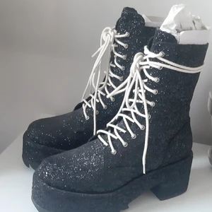 Dolls kill boots - Svarta glittrande Dolls Kill boots,  i storlek 41. Oanvända/nyskick. Påminner lite om rocky horror picture show, visst? Accepterar swisch.