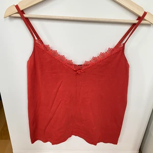 Rött linne  - Storlek: M. Plaggets längd 40cm, 38cm bredd. Betalningsmetod: Swish. Frakt tillkommer postnord blå påse 45kr