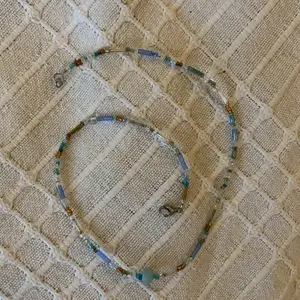 Halsband med blå/ bruna pärlor och en ljusblå sötvattenspärla 